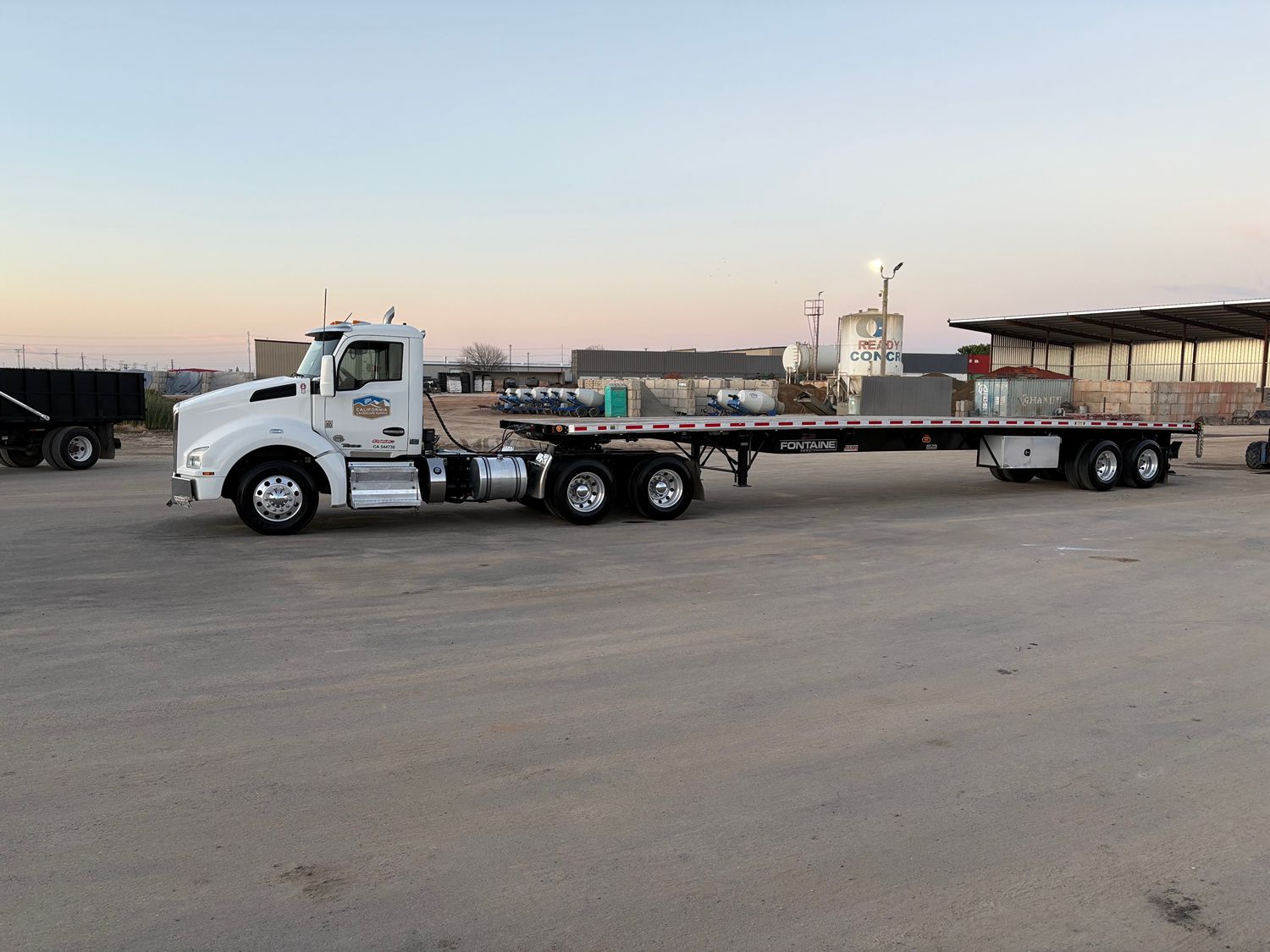 flatbed delivery truck with fork lift option for large landscape material deliveries